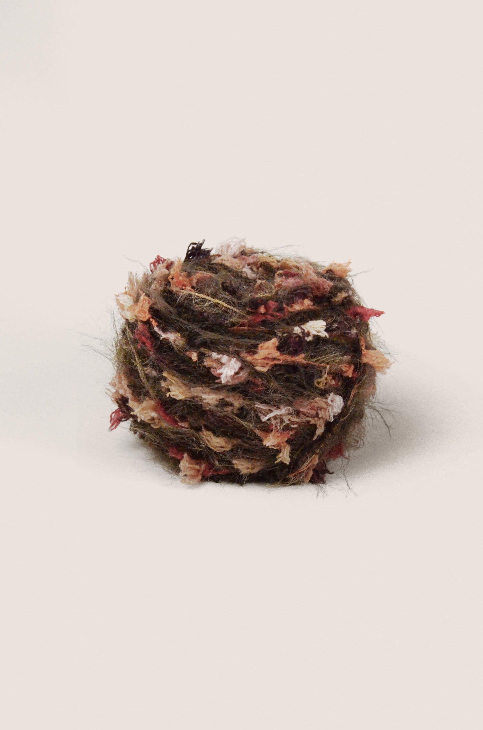 Hand-blended yarn with an earthy grey-brown base and flecks of deep red, burgundy and soft pink, inspired by the natural tones of Australian protea flowers