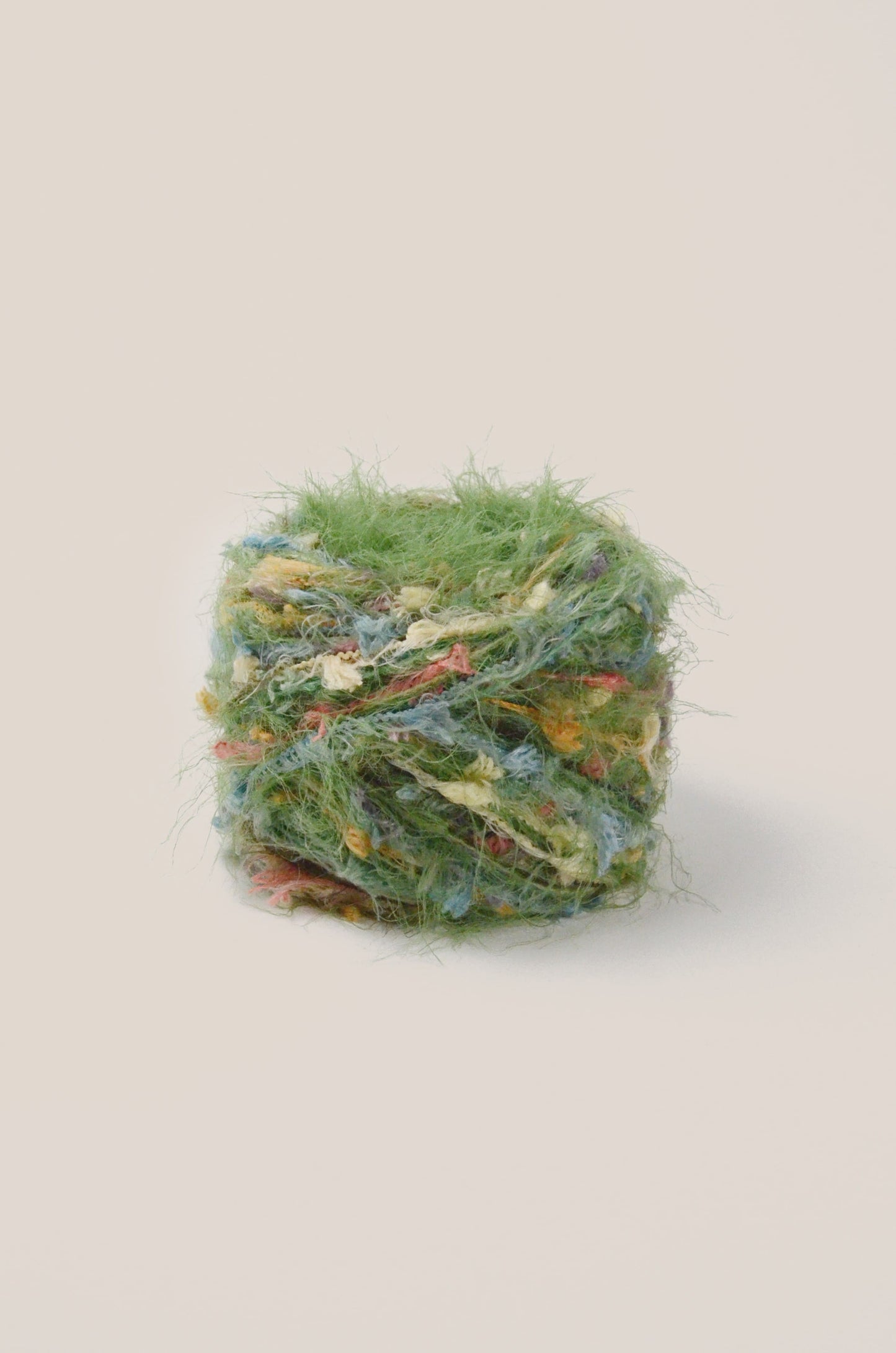 Christmas Tree hand-blended yarn – light forest green with bright multicolour threads, soft and fluffy texture inspired by woodland lights