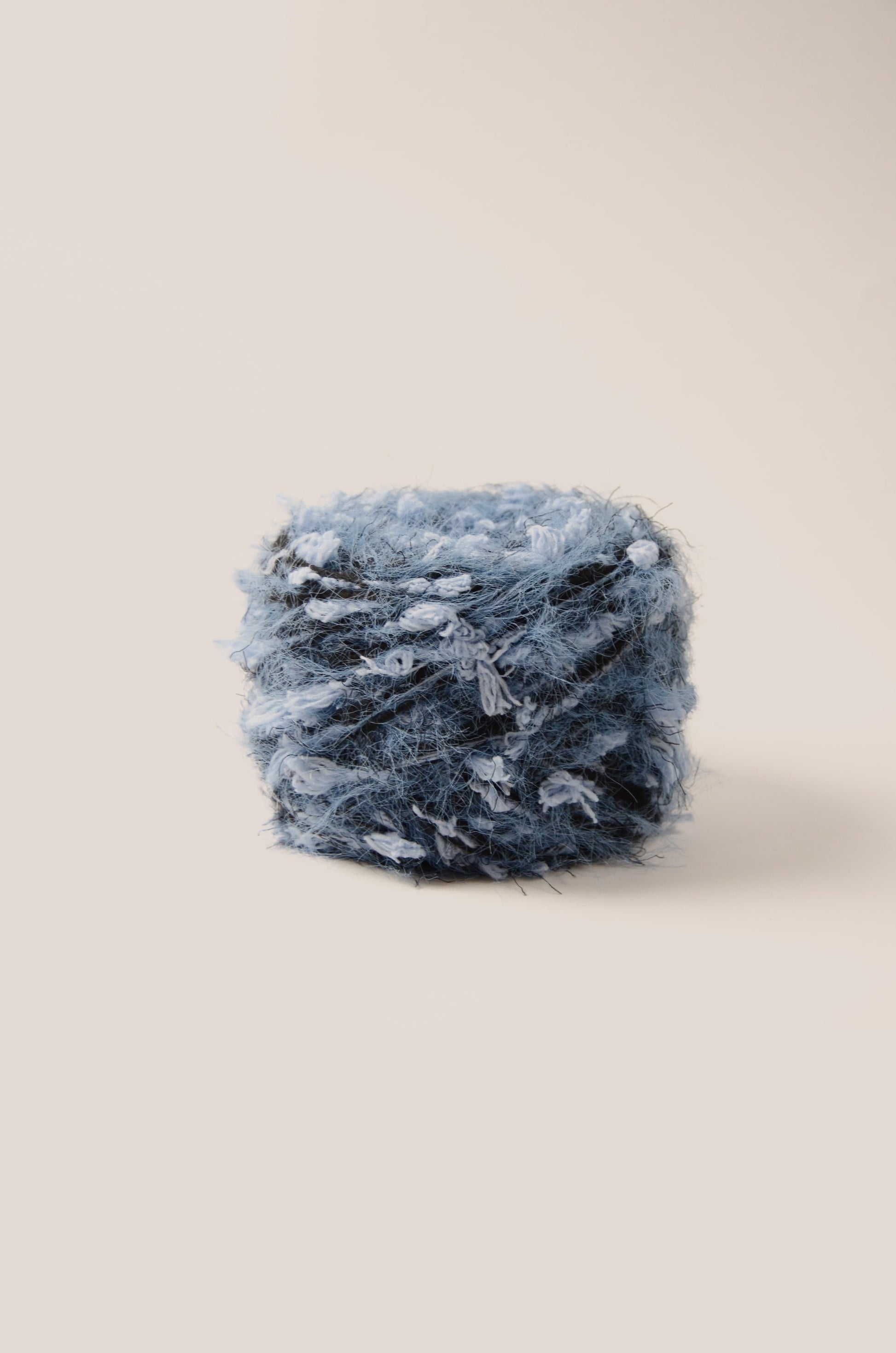 Midnight Tide hand-blended yarn – deep ocean blue base with soft blue and black threads, fluffy texture inspired by moonlit sea waves