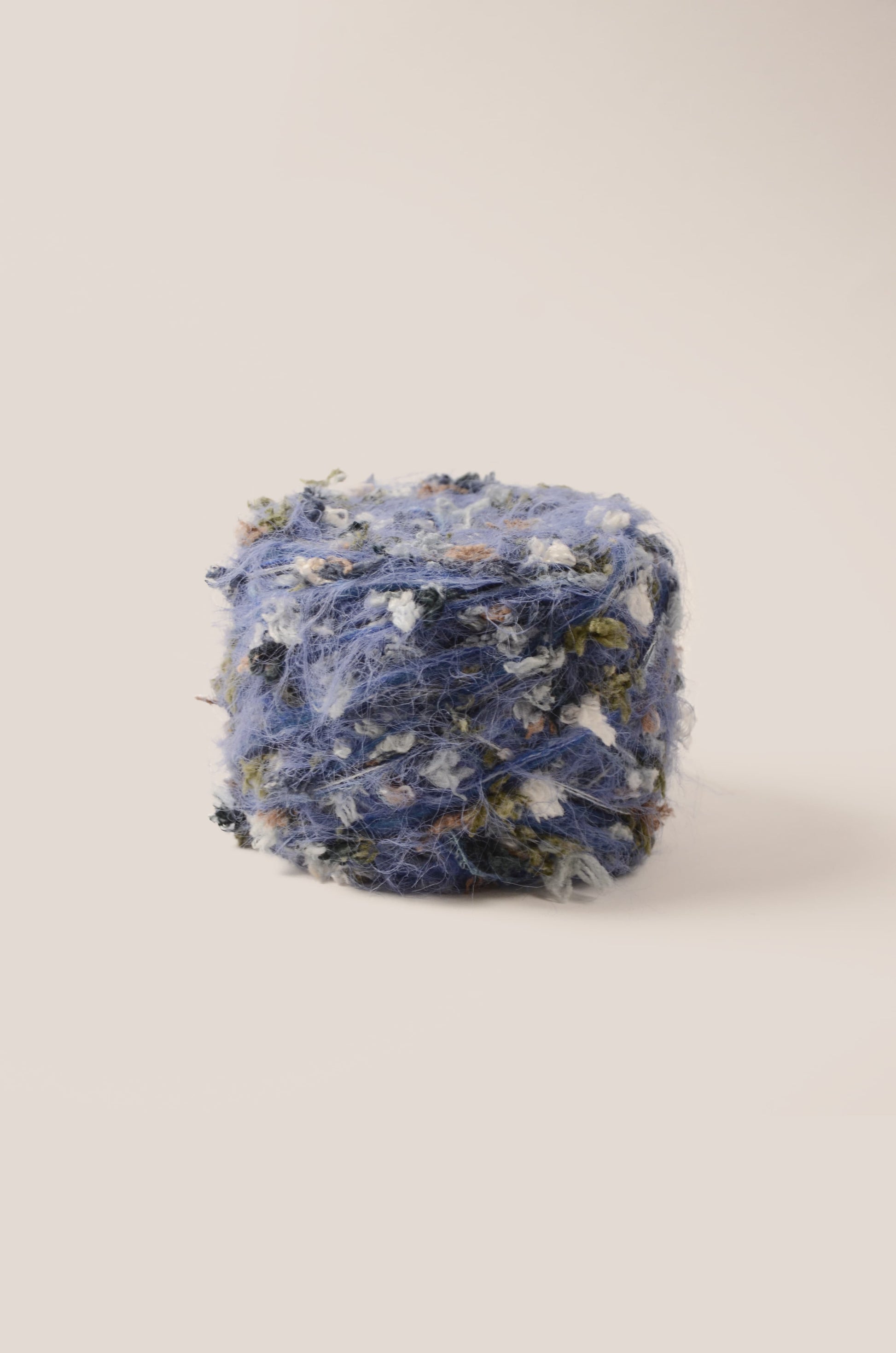 Twilight Indigo hand-blended yarn – deep indigo base with shadow green, white, and subtle brown threads, fluffy texture inspired by twilight ocean tones